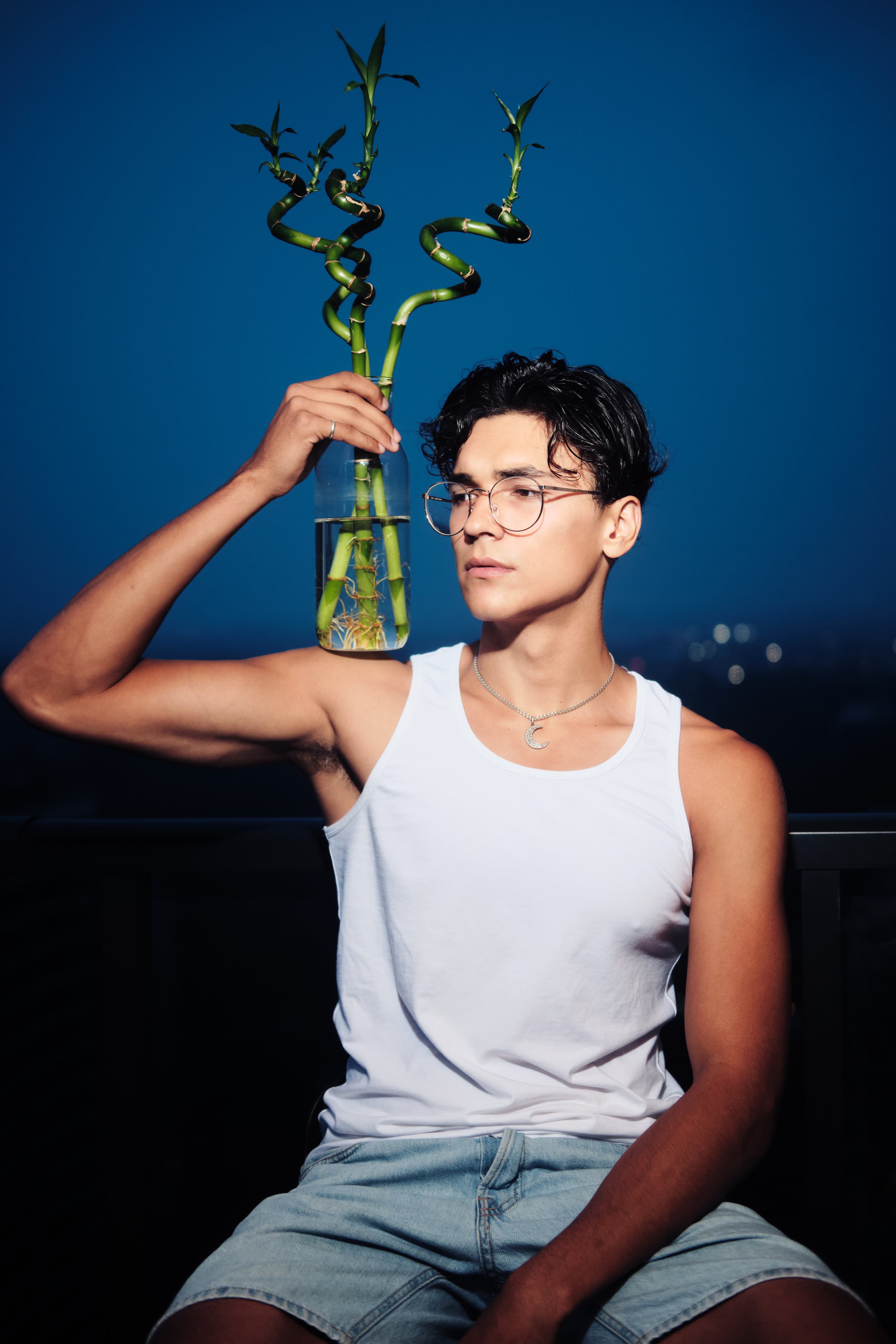 Blue editorial portrait with bamboo
